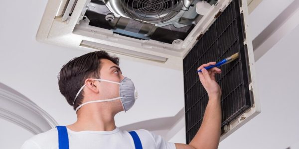 worker-repairing-ceiling-air-conditioning-unit_656932-2302